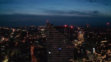 Uzun, modern gökdelenlerin yükselen görüntüleri. Şehir merkezindeki gökdelenlerle panoramik manzarayı gözler önüne seriyor. Gece manzarası. Varşova, Polonya