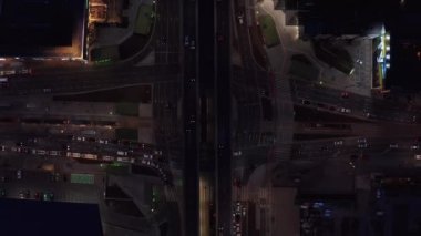 Havadan kuşların gözü tepede. Yoğun çoklu şeritli ve çok katlı kavşakların yükselen görüntüleri. Arabalar gece şehrinden geçiyor. Varşova, Polonya