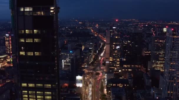 Tilt down shot heavy traffic in wide multilane street. Aerial view of downtown at night. Warsaw, Poland — Stock Video