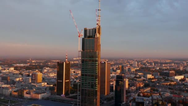 Morning forwards fly towards construction site of tall downtown office of apartment building. Warsaw, Poland — Stock Video