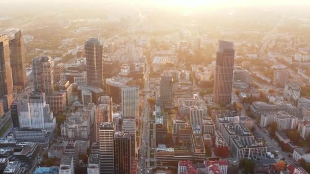 Aerial panoramic footage of high rise downtown buildings. Shot against morning glowing sun. Warsaw, Poland — Stock Video