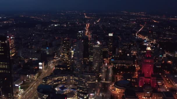 Diapositiva y panorámica de la ciudad por la noche. Imágenes panorámicas aéreas con el centro comercial Zlote Tarasy y el Palacio de Cultura y Ciencia. Varsovia, Polonia — Vídeos de Stock