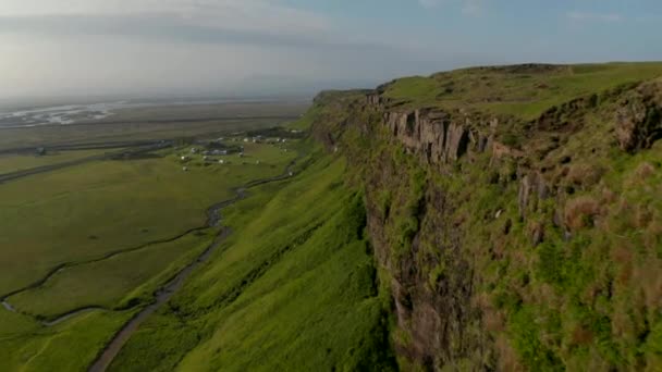 Ptačí oko letí k úchvatnému Seljalandsfoss vodopádu, nejslavnější kaskádě na Islandu. Dron pohled na úžasné icelandské krajiny nad mechem útesy a majestátní vodopád — Stock video