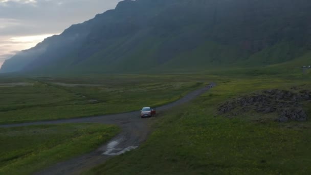 Birds μάτι τροχιά άποψη του τέσσερα από τέσσερα εκτός δρόμου αυτοκίνητο σταθμευμένο σε χλοώδη ορεινή της Ισλανδίας. Αεροφωτογραφία Ενοικίαση αυτοκινήτου σταθμευμένο σε εκπληκτική ύπαιθρο στη Νότια Ισλανδία — Αρχείο Βίντεο