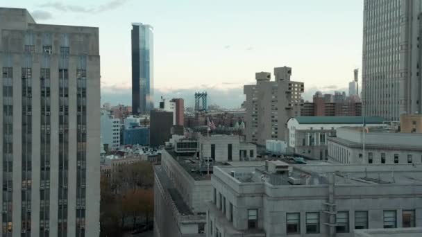 Vorwärts fliegen über die Gebäude des Bürgerzentrums. Amerikanische Flagge am Mast über dem Gebäude. Schrägseilbrücke im Hintergrund. Manhattan, New York City, USA — Stockvideo