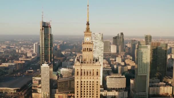 Ascending shot of top of historic high rise PKIN building. Modern downtown skyscrapers in background. Warsaw, Poland — Stock Video