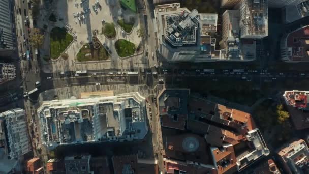 Aerial birds eye overhead top down ascending footage of vehicles driving on busy roads around high rise buildings at Spain square. — Stock Video