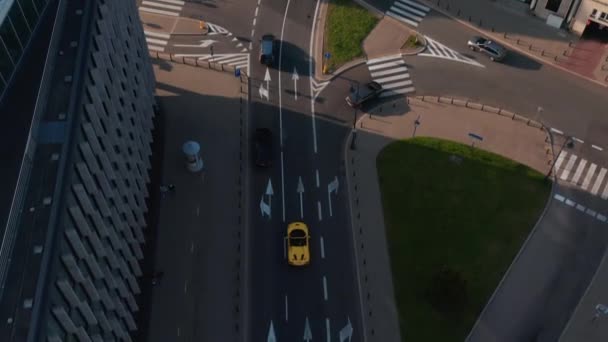 Birds eye view of cars driving in street of city. Tracking of yellow convertible sports car in old town. Warsaw, Poland — Stock Video