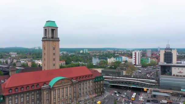 Two coupled units of Intercity express train arriving to train station. Aerial view of traffic in city. Fly around historic town hall building. Berlin, Germany — Stock Video