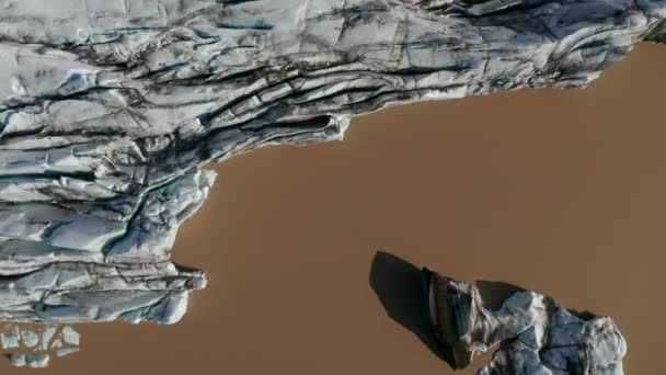 Felett kilátás nyílik a Breidamerkurjokull gleccser jég repedt kialakulását sár Vatnajokull tó nemzeti park. Környezetvédelem. Felülnézetből gleccser minta jég és lagúna — Stock videók