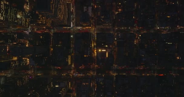 Aerial birds eye overhead top down panning view of building blocks at night. Fly above town development. Manhattan, New York City, USA — Stock Video