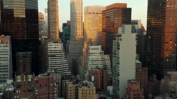 High rise buildings in midtown at dusk. Tall office towers illuminated by setting sun. Manhattan, New York City, USA — Stock Video