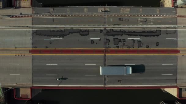 Aerial birds eye overhead top down ascending shot cars driving on multilane road bridge over water. Bascule bridge from height. New York City, USA — Video Stock