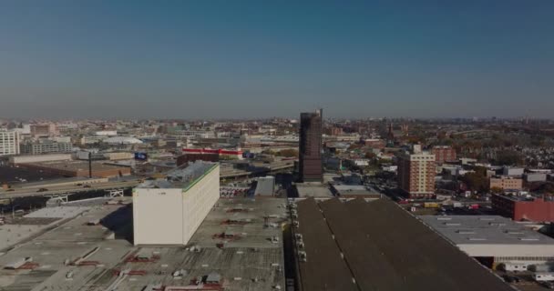 Aerial panoramic view of highway passing through commercial town borough. Production or logistic halls along road. Queens, New York City, USA — Stock Video