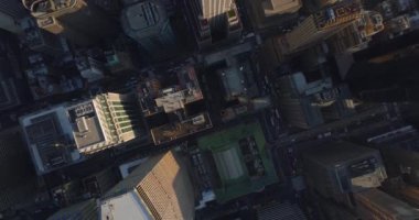 Hava kuşları şehir merkezindeki caddelerin yoğun trafiğini yukarıdan görüyor. Yüksek binalar arasında yavaşça hareket eden araçlar. Manhattan, New York City, ABD
