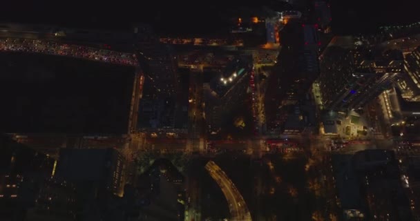 High angle footage of heavy traffic on multilane road at night. Flow of slowly moving cars on expressway around high rise buildings. Manhattan, New York City, USA — Stock Video