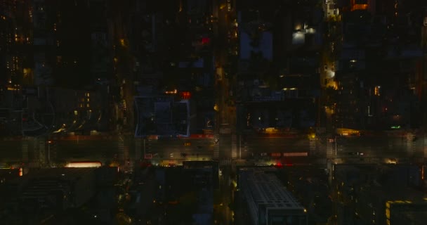 Aerial birds eye overhead top down view blocks of buildings between two multilane one way avenues. Low traffic in night city. Manhattan, New York City, USA — Stockvideo