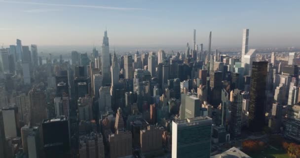 Slide and pan footage of skyscrapers in midtown. Aerial view of iconic One Vanderbilt, Chrysler and Empire State Building. Manhattan, New York City, USA — стоковое видео