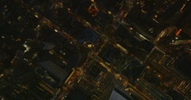 Havadan kuşların gözü yukarıdan aşağıya, caddenin aşağısında. Gece şehrindeki yüksek binaların arasındaki yollar aydınlandı. Manhattan, New York City, ABD