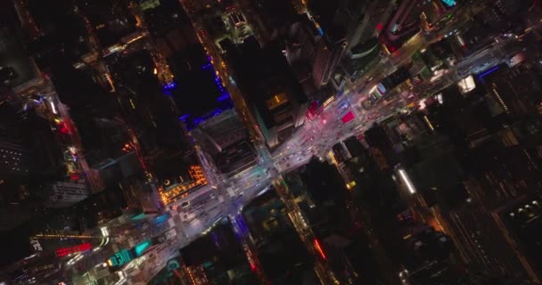 Aerial birds eye overhead top down view of traffic passing through Times Square at night. Colourful lights in midtown. Manhattan, New York City, USA — стокове відео