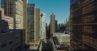 Şehirdeki yüksek binaların kayması. Pencereli parlak duvarlar boyunca uç, şehir gelişimini yansıt. Manhattan, New York City, ABD