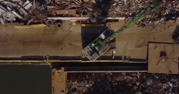 Aerial birds eye overhead top down footage of loader grabbing metal scrap and loading it to barge. Recycle and ecology concept. New York City, USA — Stockvideo