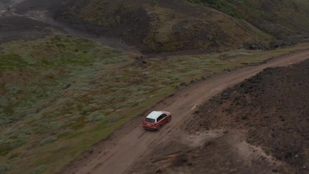 Spårning av bil på grusväg slingrande på landsbygden. Barren vulkaniska landskap. Offroadfordon. Island — Stockvideo