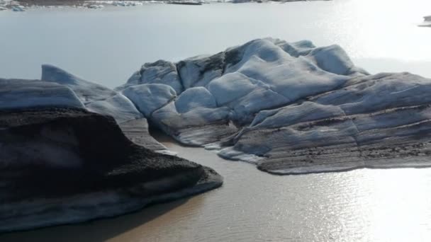 Melting iceberg floating on water surface. Arctic landscape scenery. Close-up of structure of ice surface. Iceland — Stock Video