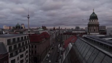 Şehrin yukarısına uç. Çatıların üzerinde yükselen ünlü simgelere sahip şehir manzarası. Franzosischer ve Berliner Dom ve Fernserturn bulutlu gökyüzüne karşı. Berlin, Almanya