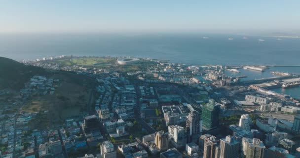 Aerial view of buildings in city and sea coast. Slide reveal of high rise buildings and seaport. Cape Town, South Africa — Stock Video