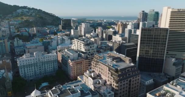 Fly about modern high rise buildings in city centre. Sea in Table Bay in background. Cape Town, South Africa — Stock Video