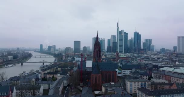 Slide and pan footage of historic Frankfurt Cathedral. River flowing through city and group of modern skyscrapers in background. Frankfurt am Main, Germany — Stock Video