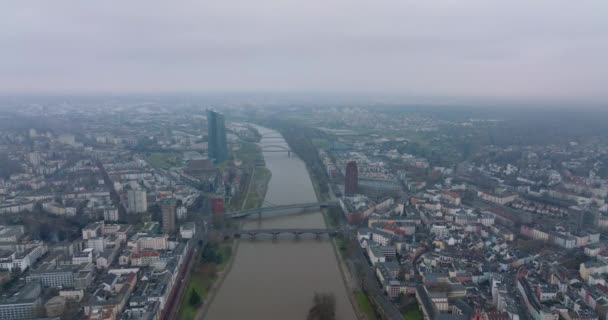 Forwards fly above large city. Various bridges spanning river. Aerial panoramic hazy view of urban neighbourhoods. Frankfurt am Main, Germany — Stock Video