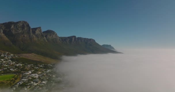 Sis yüzünden yükselen dağların görüntülerini çekiyor. Deniz kıyısında sabah sisi. Cape Town, Güney Afrika — Stok video