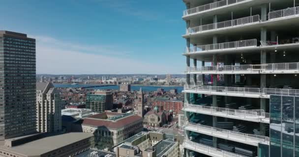 Vuelo apretado alrededor del sitio de construcción de un nuevo rascacielos. Reveladora vista panorámica aérea del desarrollo de la ciudad y el río. Boston, Estados Unidos — Vídeo de stock
