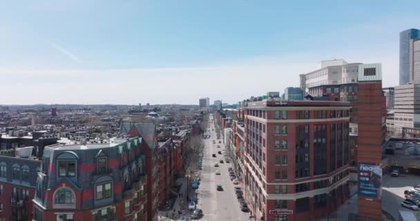 Cars driving on long straight street in residential borough. Rows of multistorey red brick apartment houses. Boston, USA — Stock Video