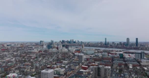 Aerial ascending shot of large city. Cityscape with high rise business buildings in background. Town divided by river. Boston, USA — Vídeo de stock