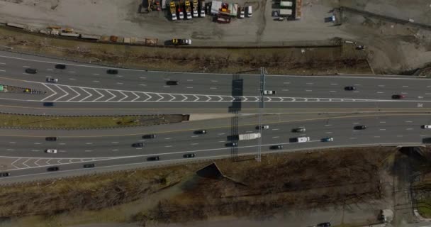 Birds eye shot of wide multilane road. Descending footage of traffic under road directions signs. Boston, USA — Video