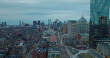 Back Bay Borough 'daki konut binalarının üzerinden uç. Uzaktaki modern yüksek binaları olan şehir manzarası. Büyük şehirde alacakaranlık. Boston, ABD