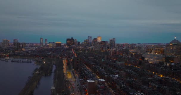 Slider obytných městských čtvrtí na nábřeží a osvětlené mrakodrapy v centru města v dálce. Boston, USA — Stock video