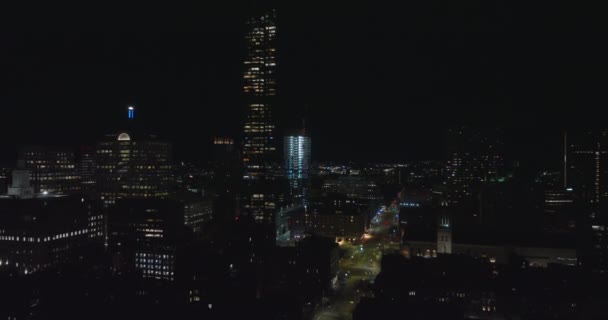 Przód przelatuję nad wieczorowy miejski dzielnica. Różne zabudowy w nocy, odsłaniające plac budowy wieżowca. Boston, USA — Wideo stockowe