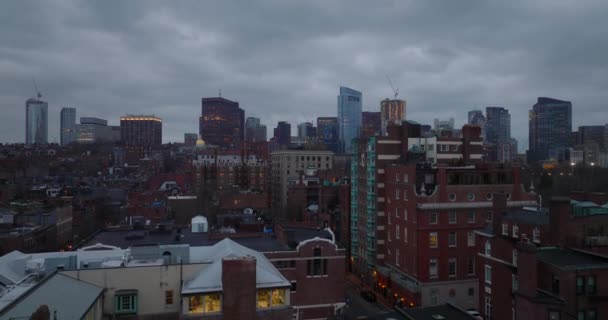 Residential brick buildings in Back Bay borough and downtown high rise office towers against overcast sky at twilight. Boston, USA — стоковое видео