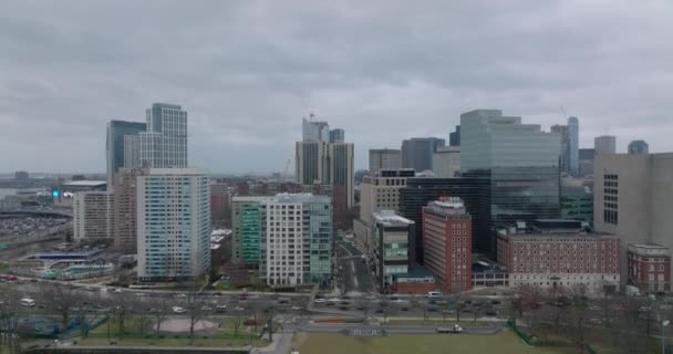 Aerial ascending footage of high rise buildings in urban borough. Busy multilane roads leading around. Boston, USA — Stock Video