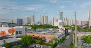 Şehirdeki çeşitli binaların havadan yükselme görüntüleri. Arka planda rıhtımdaki yüksek katlı apartman evleri. Miami, ABD