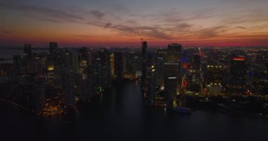 Metropolis 'in günbatımından sonraki romantik görüntüleri. Renkli alacakaranlık gökyüzüne karşı gökdelenler ve caddeler aydınlandı. Miami, ABD