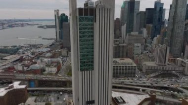 Şehirdeki yüksek binaların etrafında sıkı bir uçuş. Cam ve beton cepheli ofis kulesi. Caddelerde yoğun trafik var. Manhattan, New York City, ABD.