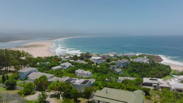 Slide Pan Shot Family Houses Residencies Seaside Waves Rolling Water — стоковое видео