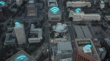Forwards fly above urban borough after sunset. Animated Wifi symbol showing available access points. Los Angeles, USA.