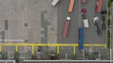 Traffic in harbour. Top down shot of logistic terminal, trucks and stacked naval containers. Intermodal transport and global logistics. Hamburg, Germany.