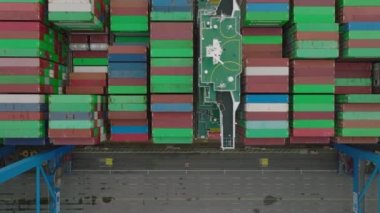 Top down shot of colourful containers loading on big cargo boat. Intermodal transport and global logistics. Hamburg, Germany.